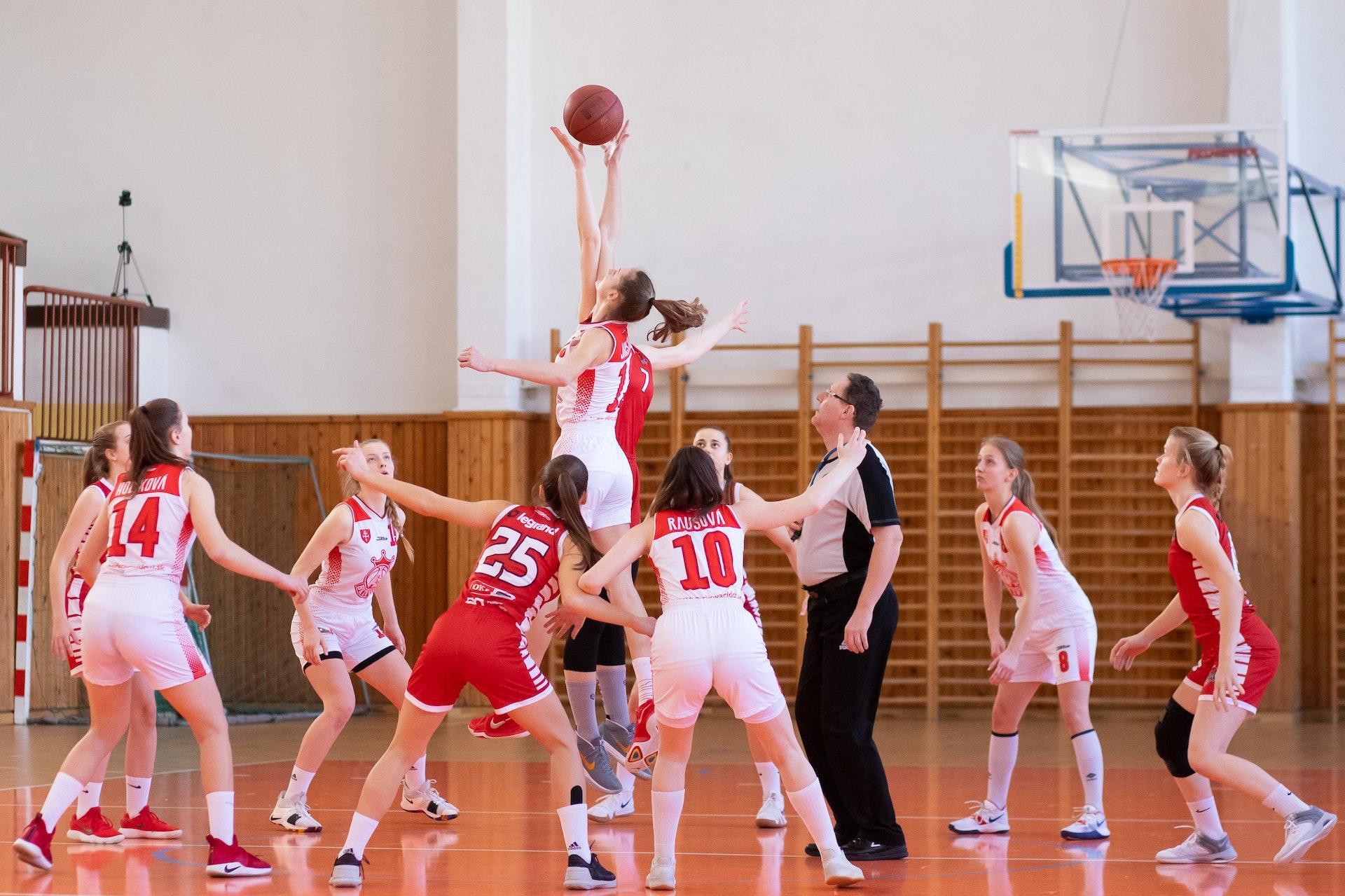 Women in Red and White Jerseys Playing Basketball